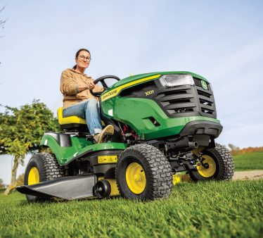 Lady riding John Deere ride-on mower